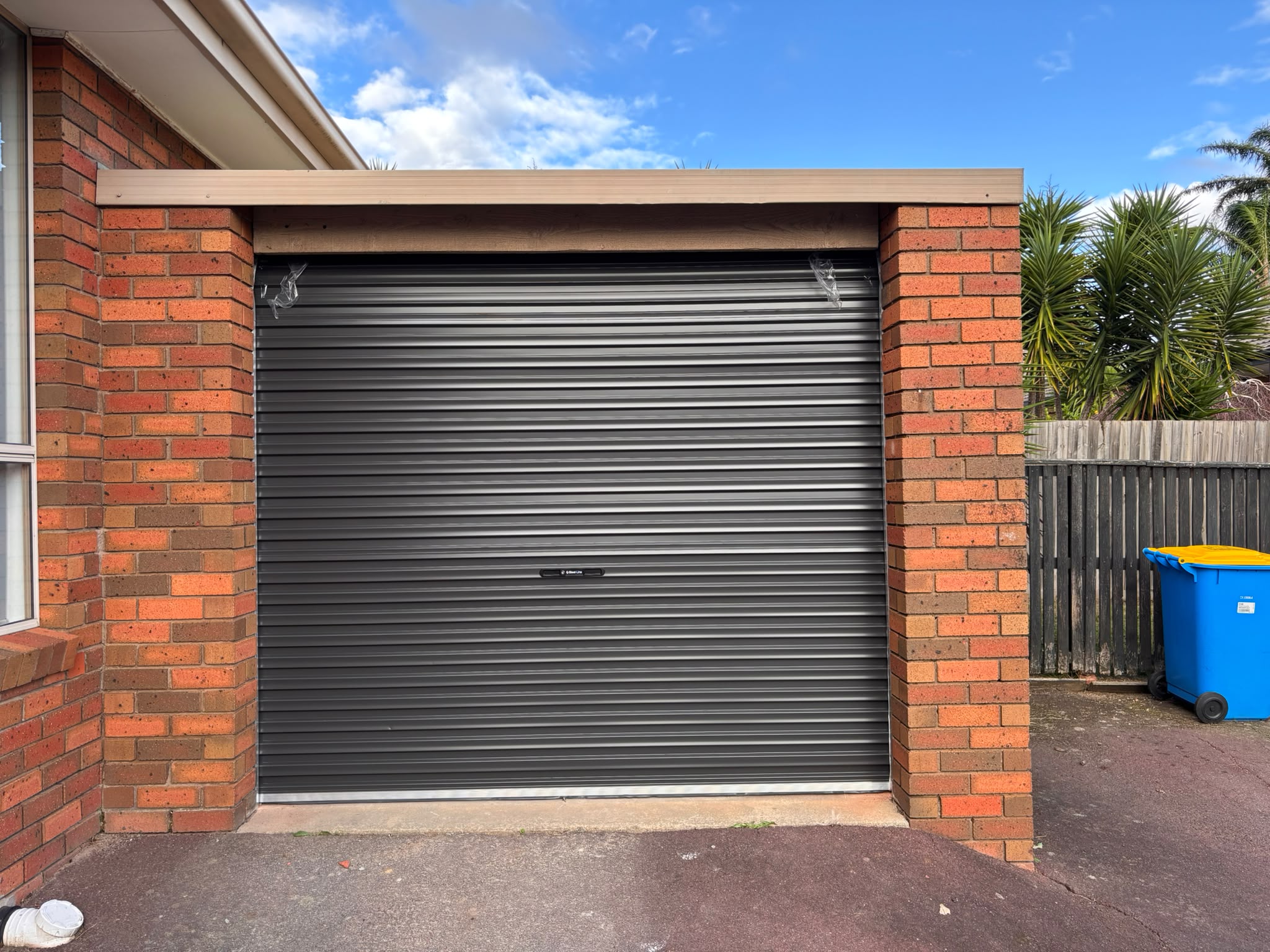 Roller garage door with brick surround